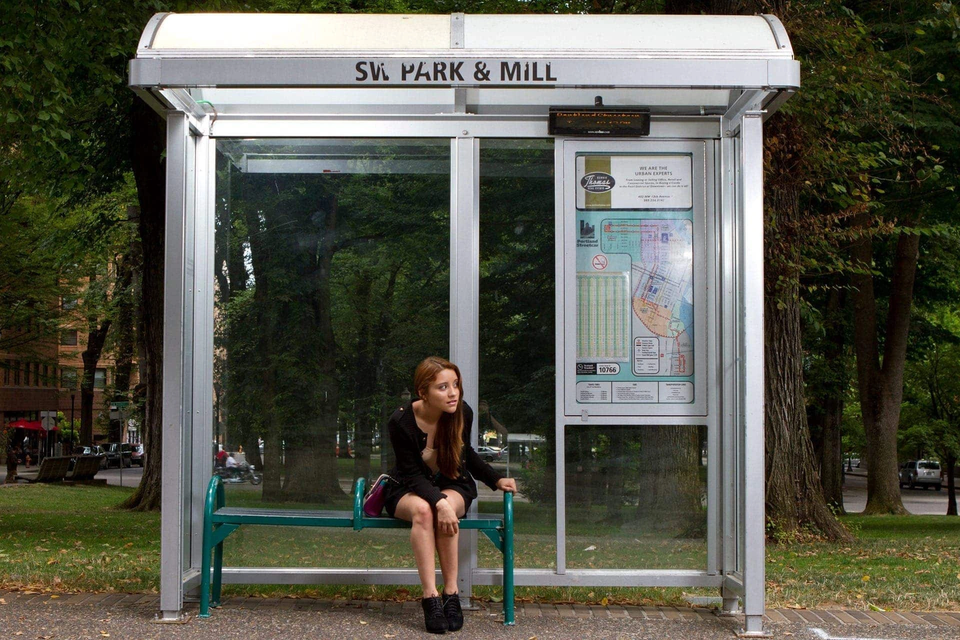 Passenger waiting at a traditional bus stop